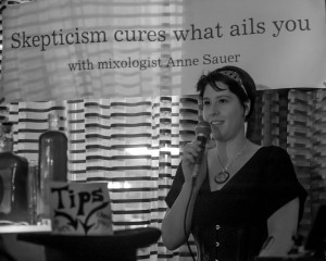 Anne gives her talk about the amazing Skepchick Cure-All at the Skepchick room party - CONvergence 2013. Photo by Jamie Bernstein.
